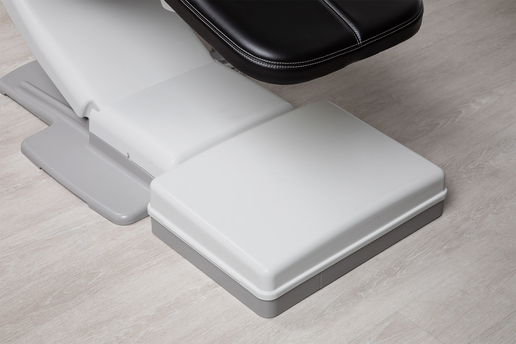Angled view of A-dec Maintain floor box cover on a wood floor