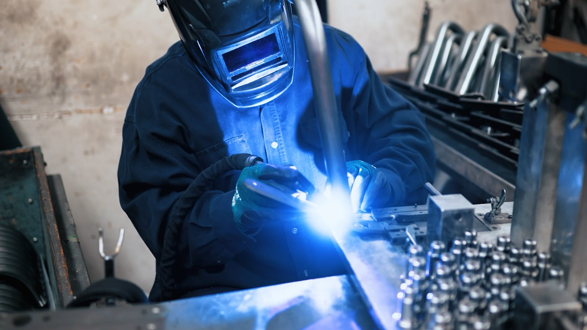 An A-dec worker welds dental equipment components together