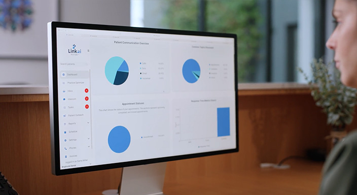 Image of a front desk employee at a dental office using Link AI to visualize practice insights