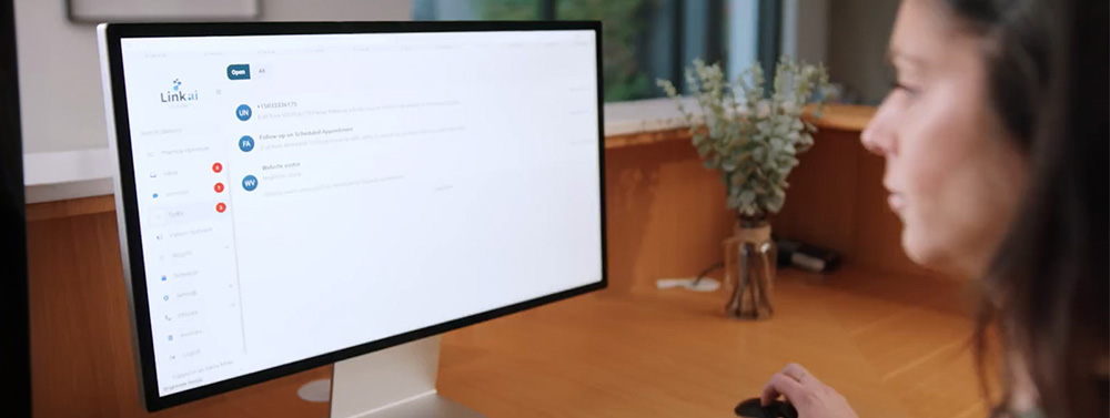 A dental office employee looking at the Link AI inbox